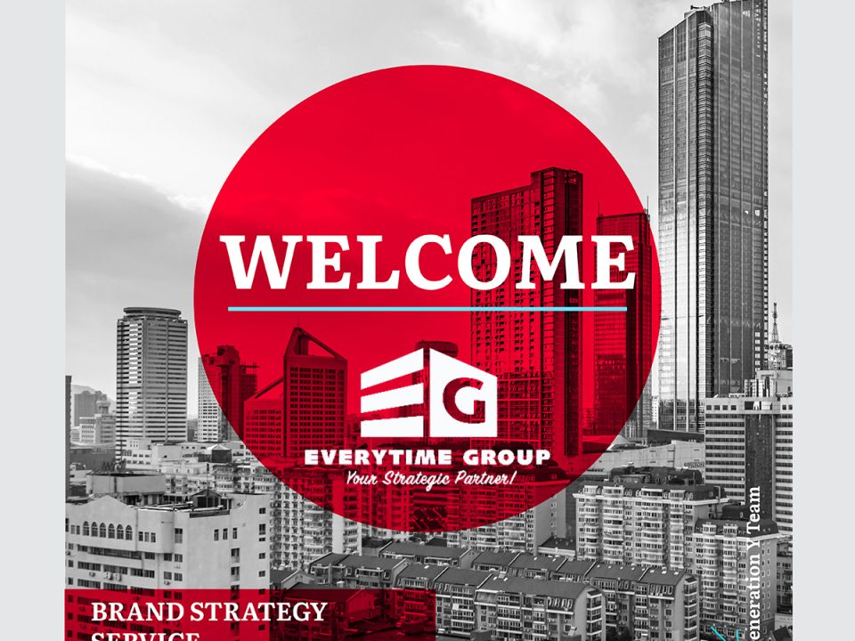 Welcome announcement graphic for Everytime Group partnership with Generation Y. Black and white cityscape of modern high-rise buildings with prominent red circular overlay containing Everytime Group logo and tagline 'Your Strategic Partner.' Text at bottom reads 'Brand Strategy Service' indicating the nature of the collaboration.